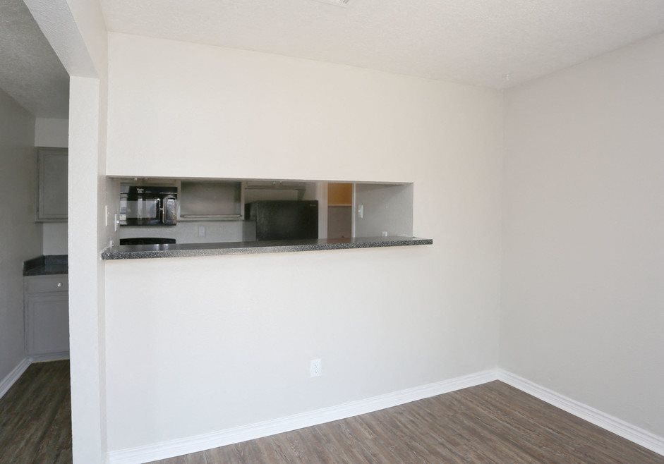 A kitchen area with a counter and cabinets.